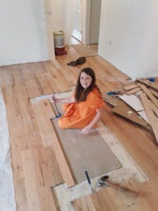 Damaris does some floor repair.